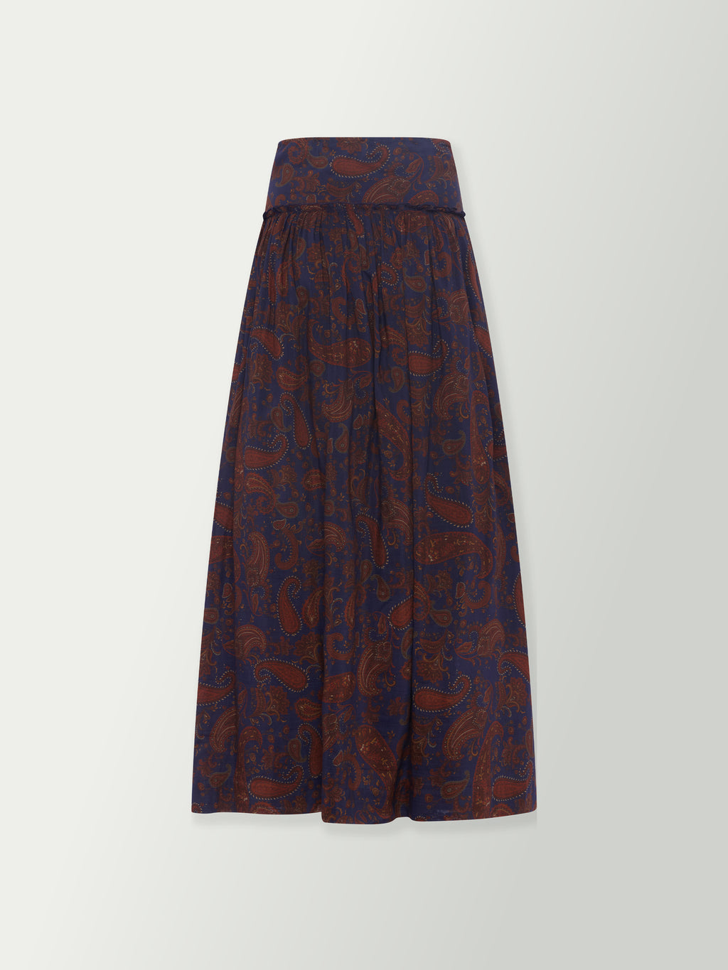 Long paisley print skirt in dark blue with rust tones, gathered waist and flared hem.