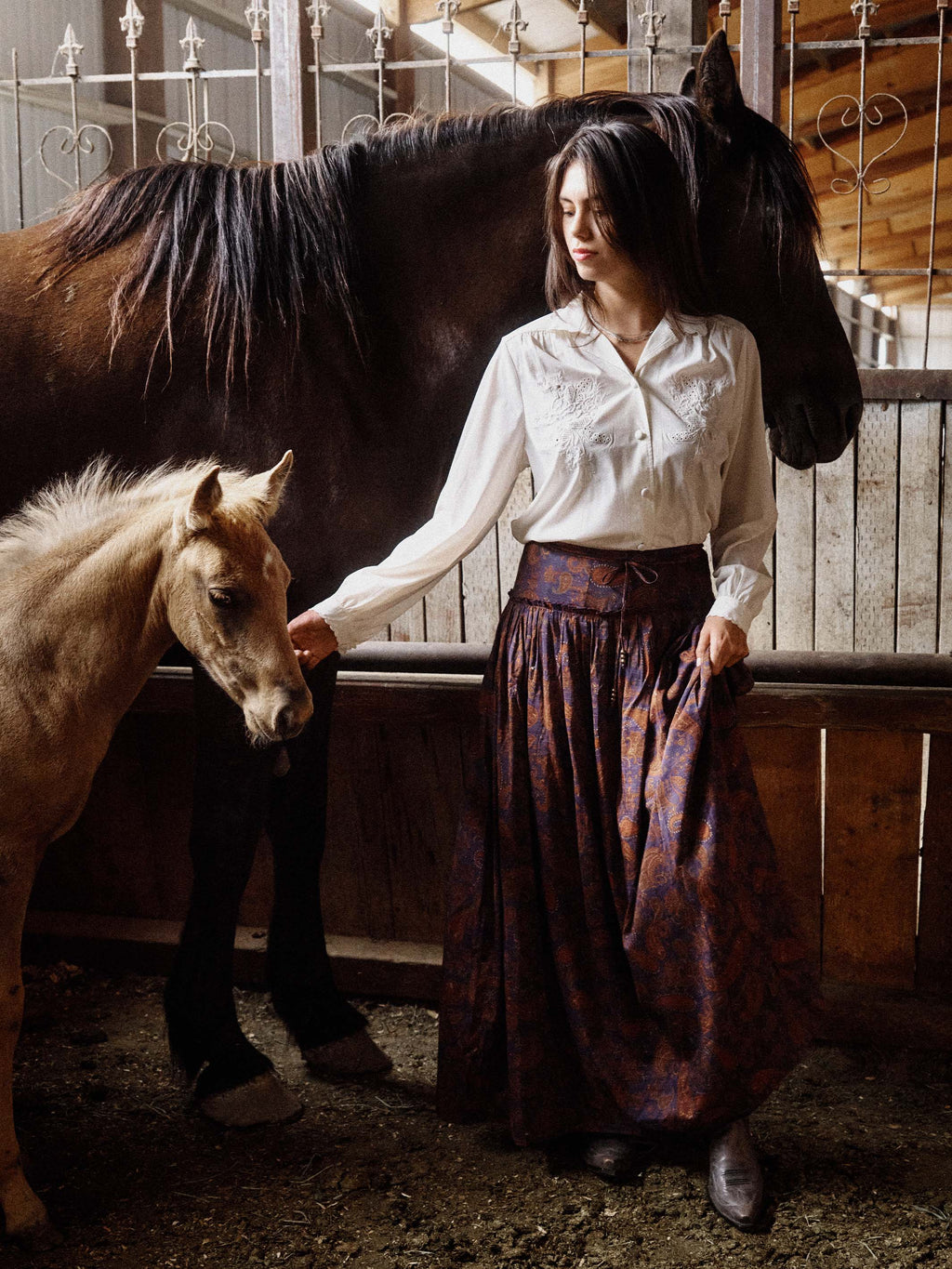 Dark blue maxi skirt with rust paisley pattern, gathered waist and full flowing shape.