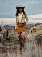 Tuscany suede mini skirt worn with western hat and boots