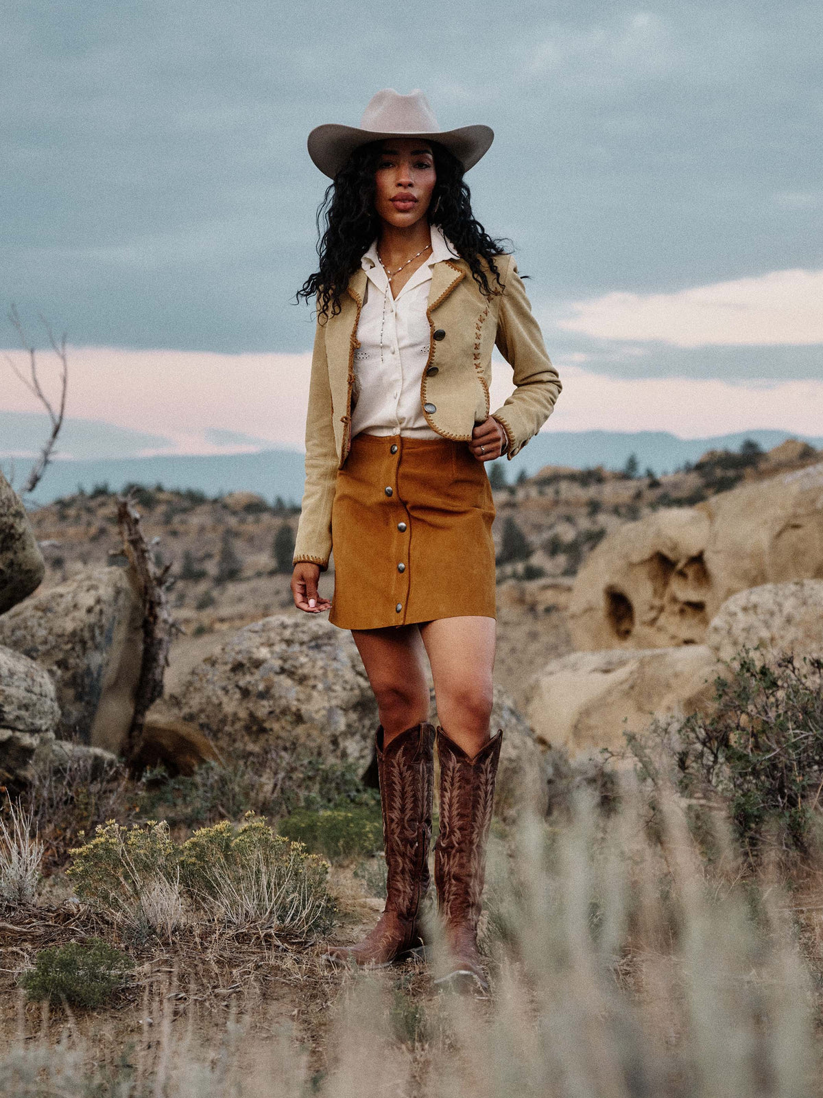 Tuscany suede mini skirt worn with western hat and boots