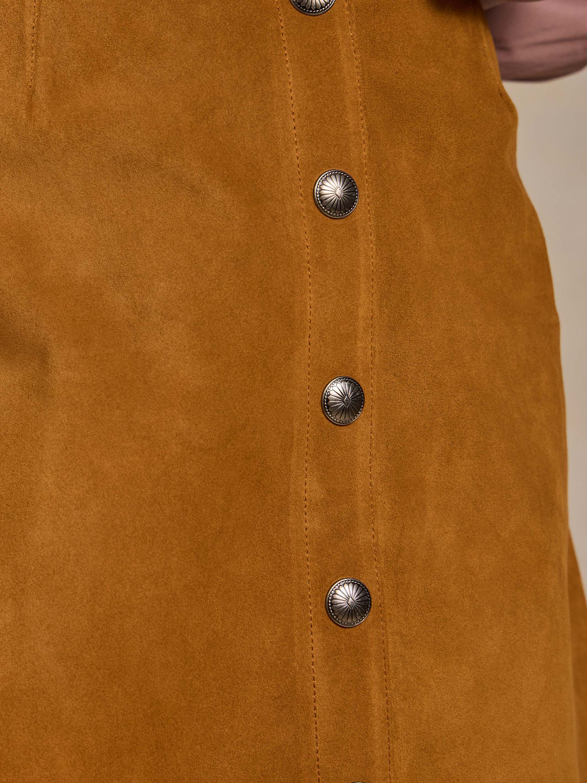 Tuscany suede skirt front: vertical seam and metal snap buttons