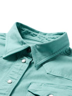 Turquoise women's snap-front denim shirt detail: snap buttons at collar and chest