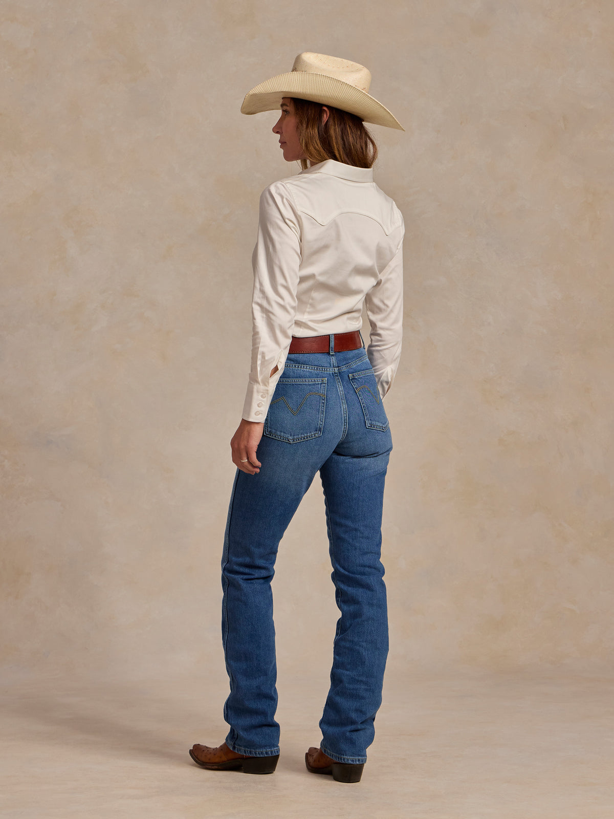 Women’s white button-up shirt viewed from back with long sleeves and collar seam