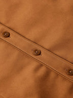 Dark caramel button placket detail with round buttons and stitched seams