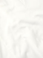 White shirt fabric close-up with smooth weave and subtle creasing