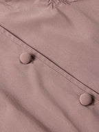 Washed plum blouse button placket close-up with round buttons and stitched seams