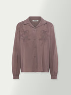 Washed plum blouse front with stand collar and lace-like embroidery on the chest