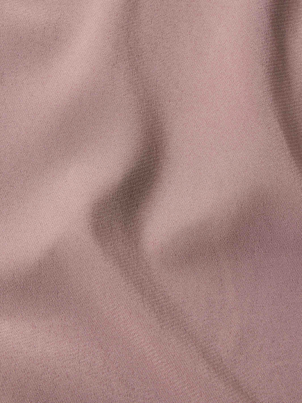 Washed plum blouse fabric texture in a smooth, woven finish