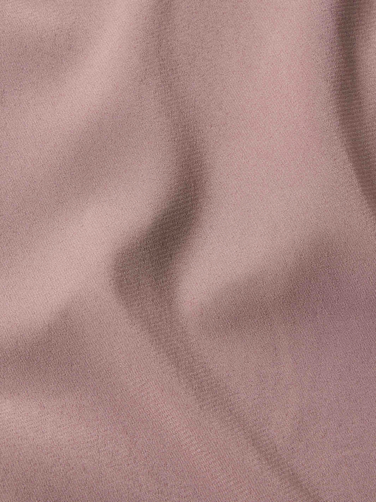Washed plum blouse fabric texture in a smooth, woven finish