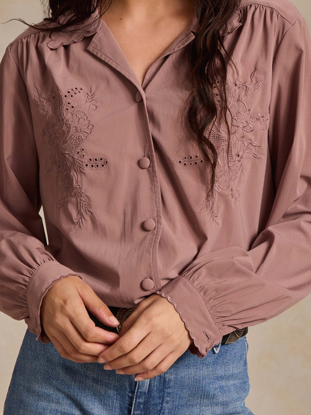 Washed plum blouse close-up with embroidered yoke and button placket