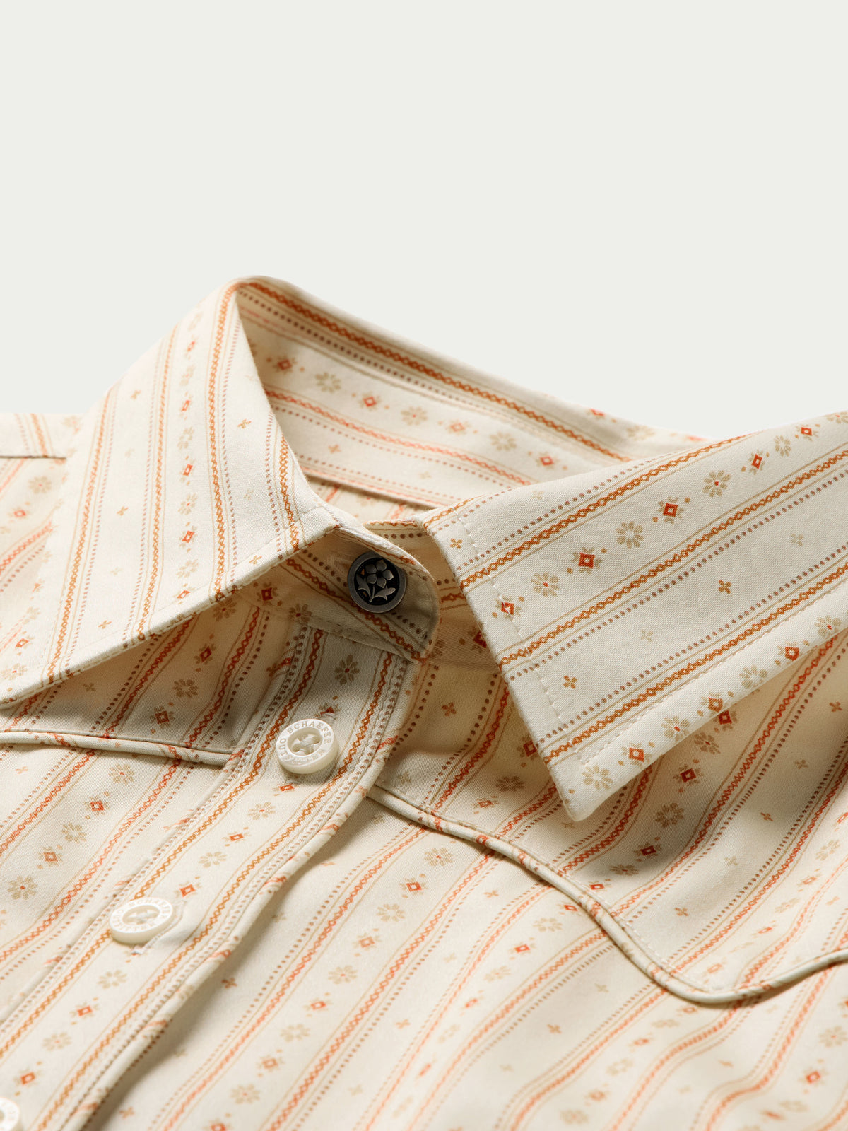 Women's printed button-up shirt collar and placket with white buttons