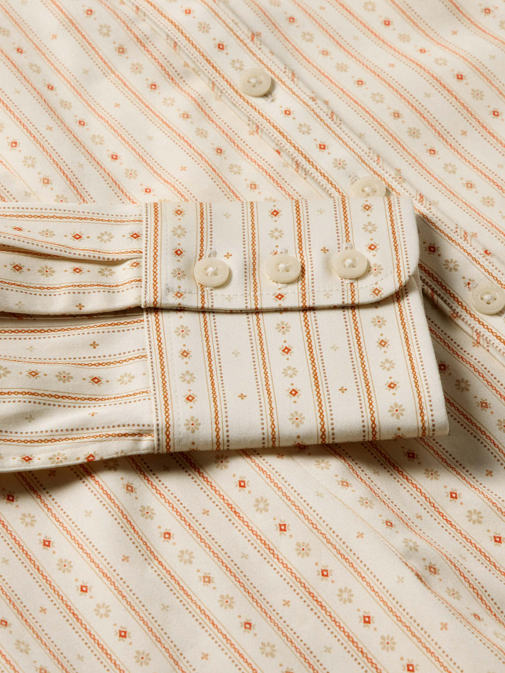 Women's printed button-up shirt front with button placket and patterned stripes