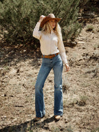 Women's printed button-up shirt on model with long sleeves and striped print