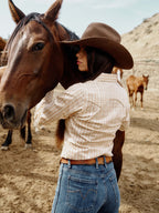 Women's printed button-up shirt on model with long sleeves and striped print