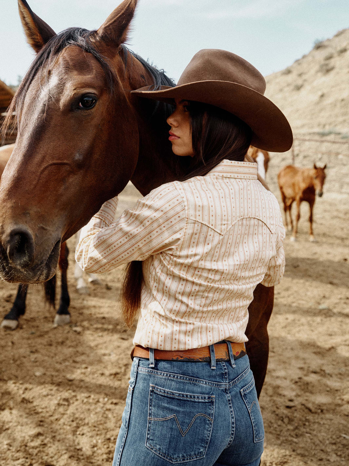 Women's printed button-up shirt on model with long sleeves and striped print