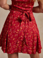 Red floral mini dress with V-neck and gathered, knotted waist detail