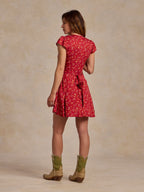 Red floral mini dress back view with gathered waist and cap sleeves
