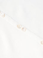 Bone sleeveless dress fabric detail with vertical texture and small gold buttons