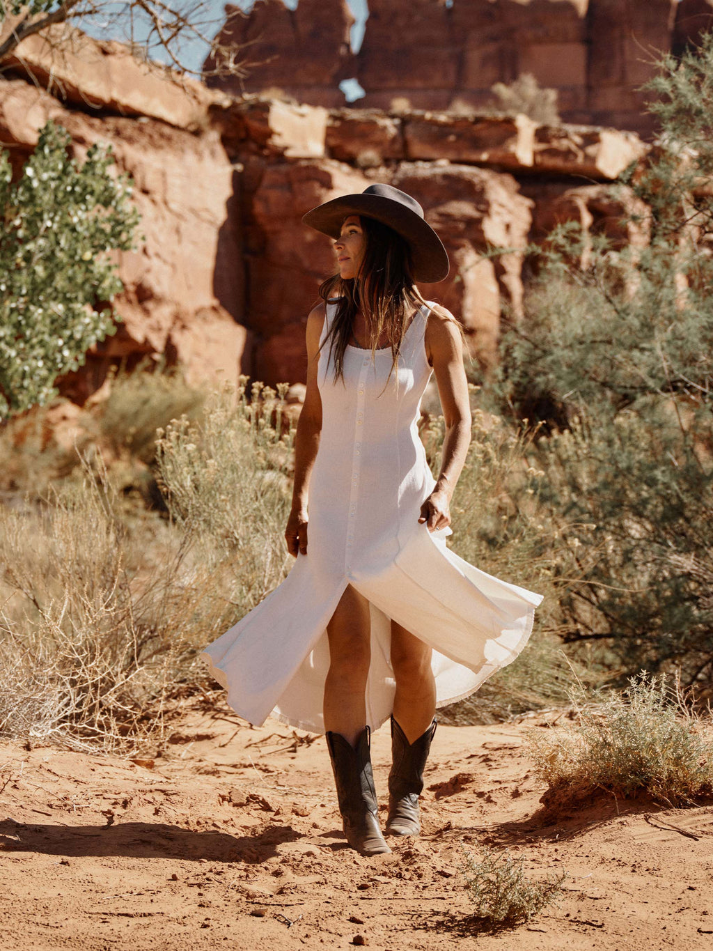 Bone sleeveless dress with scoop neckline and flowing asymmetrical hem