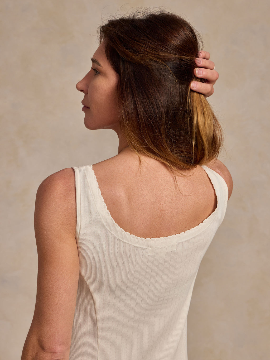 Bone sleeveless dress back view with scoop neckline and textured fabric