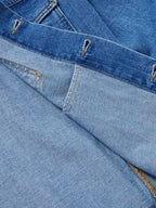 Indigo denim jacket yoke seam and contrast topstitching with metal snaps