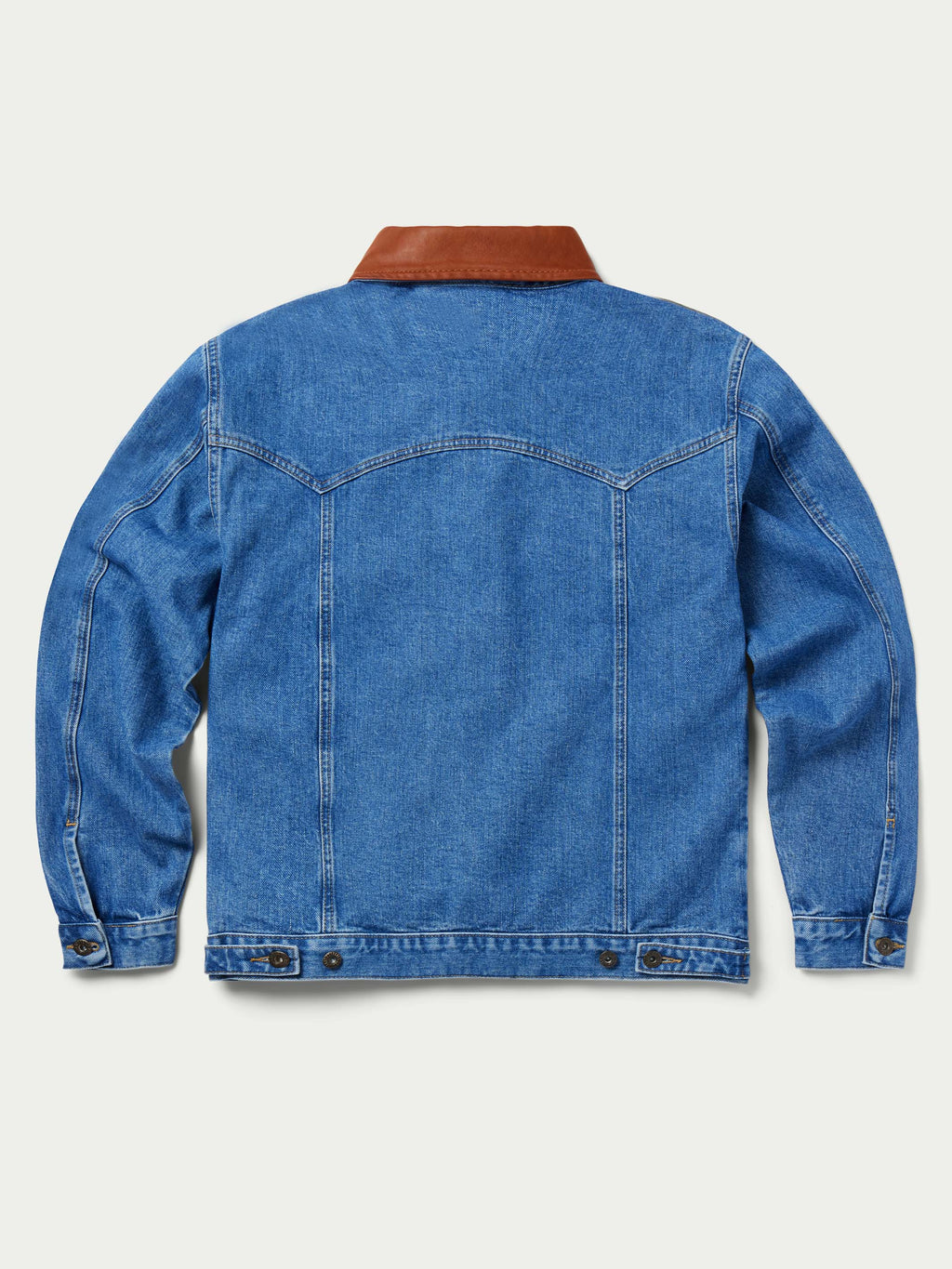 Back view of medium indigo denim jacket with brown collar and button cuffs
