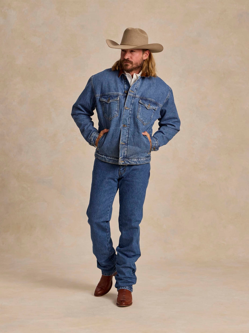 Medium indigo fleece-lined denim jacket with western snap chest pockets and button front