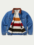 Indigo denim jacket open to show striped fleece lining in red, white, and tan