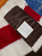 Striped fleece lining inside denim jacket with brown fabric binding and label
