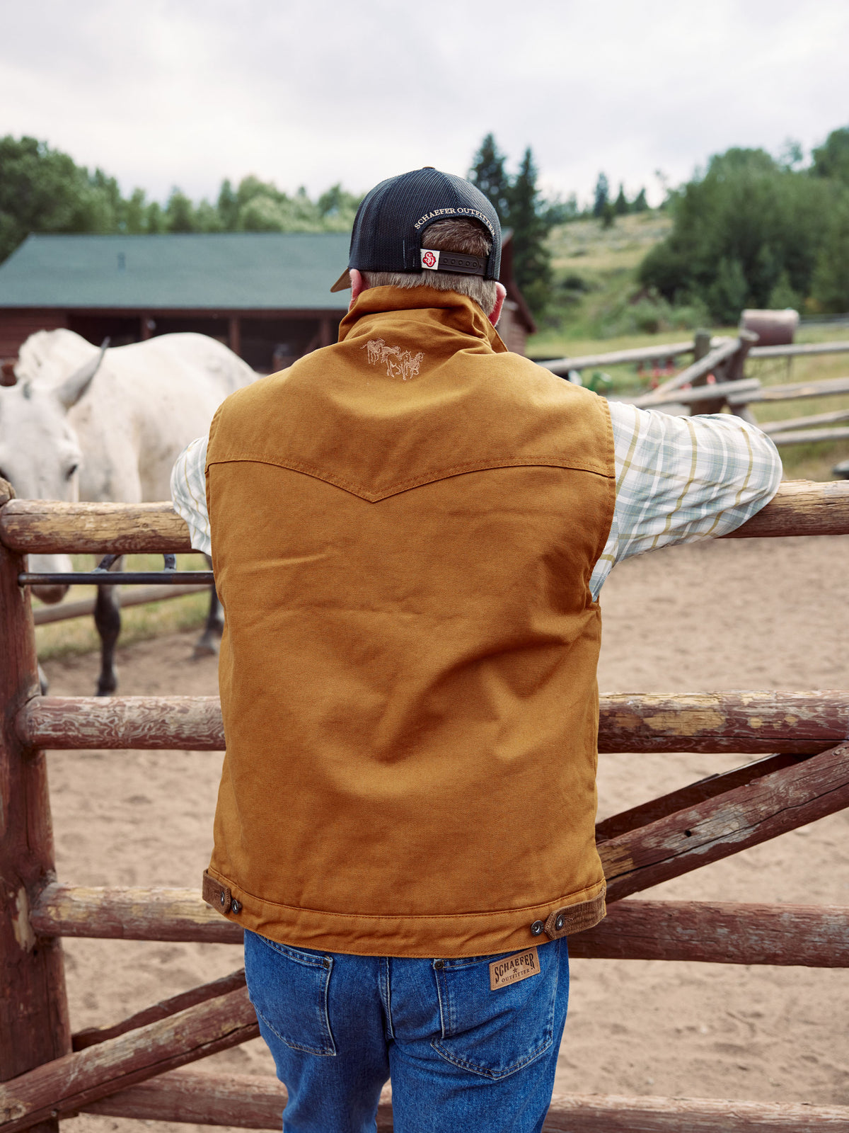 Men’s tan canvas zip-up vest with cream sherpa lining and stand collar