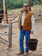 Men’s tan sherpa-lined canvas vest with front zipper and two chest pockets
