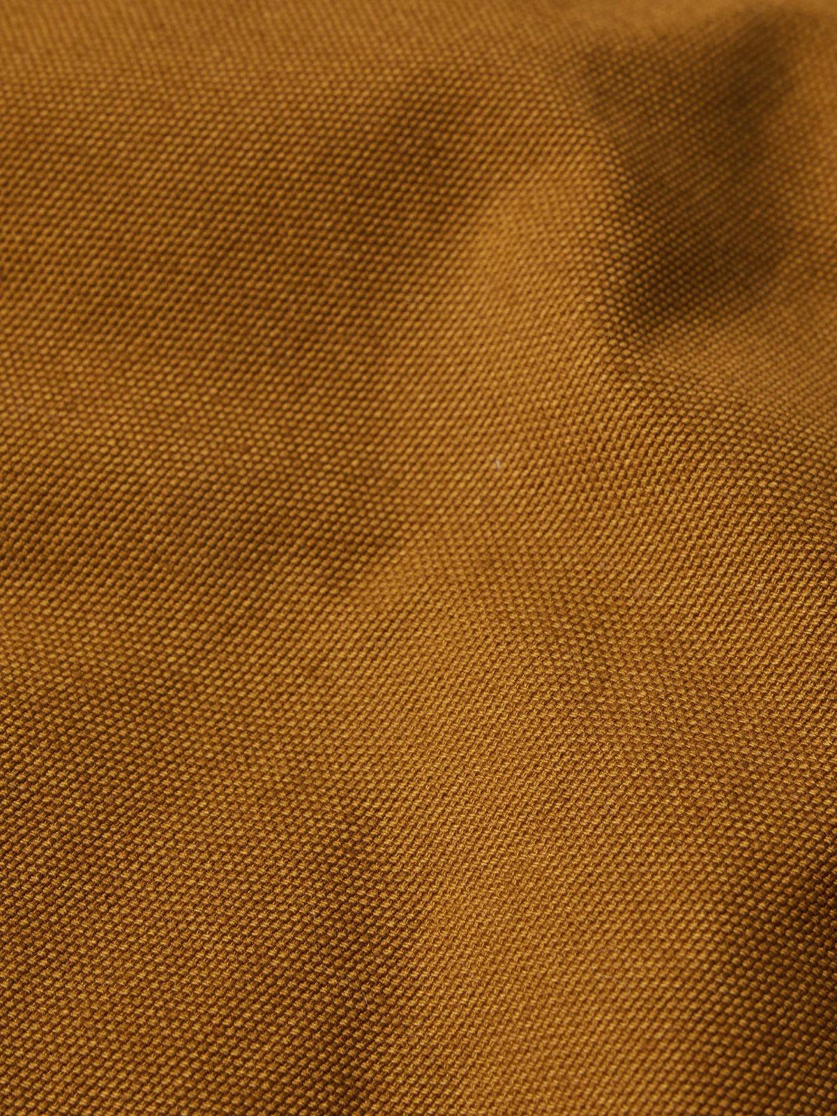 Tan canvas fabric texture close-up with fine woven surface