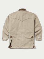 Beige drifter coat back view with brown seam accents and flap pockets