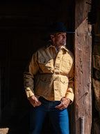 Suntan brush jacket on model with button front and two chest pockets.
