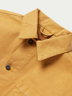 Suntan brush jacket shoulder yoke and collar with button and snap closure.