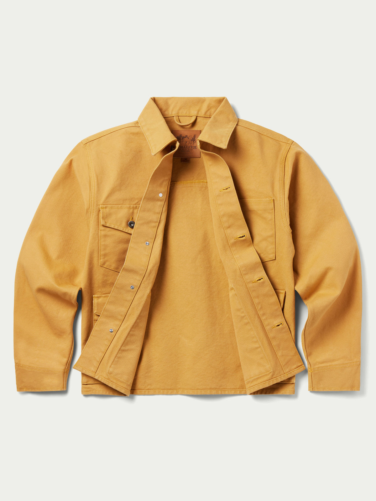 Suntan brush jacket open placket view with chest pockets and button details.