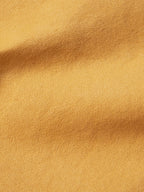Suntan brush jacket fabric texture close-up.