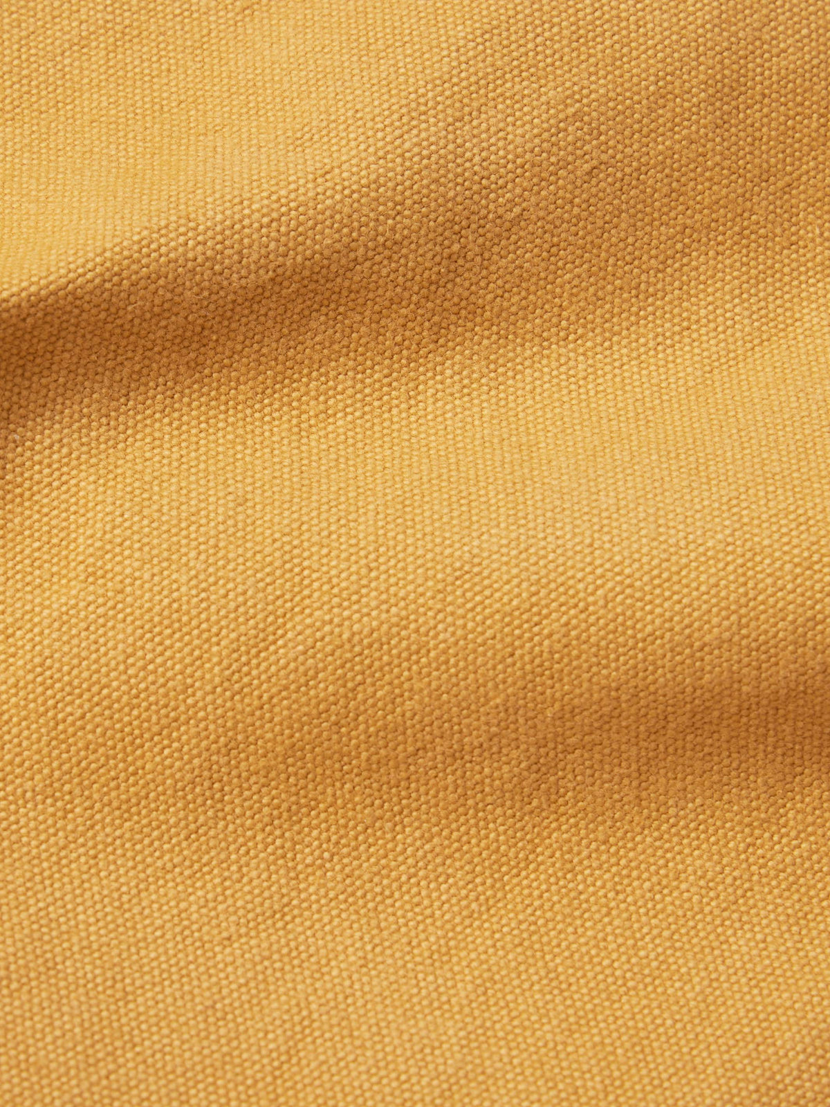 Suntan brush jacket fabric texture close-up.