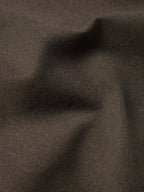 Brown canvas fabric close-up with subtle rippled grain texture