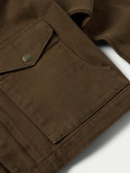 Hickory canvas jacket shoulder yoke detail with metal snap and seam stitching