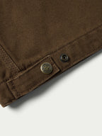 Hickory canvas jacket hem with snap buttons and small logo emblem