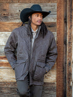 Quilted zip-front jacket with side pockets, dark charcoal color, ribbed cuffs.