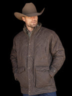 Man wearing RangeWax® quilted jacket in dark brown with stand collar and pockets