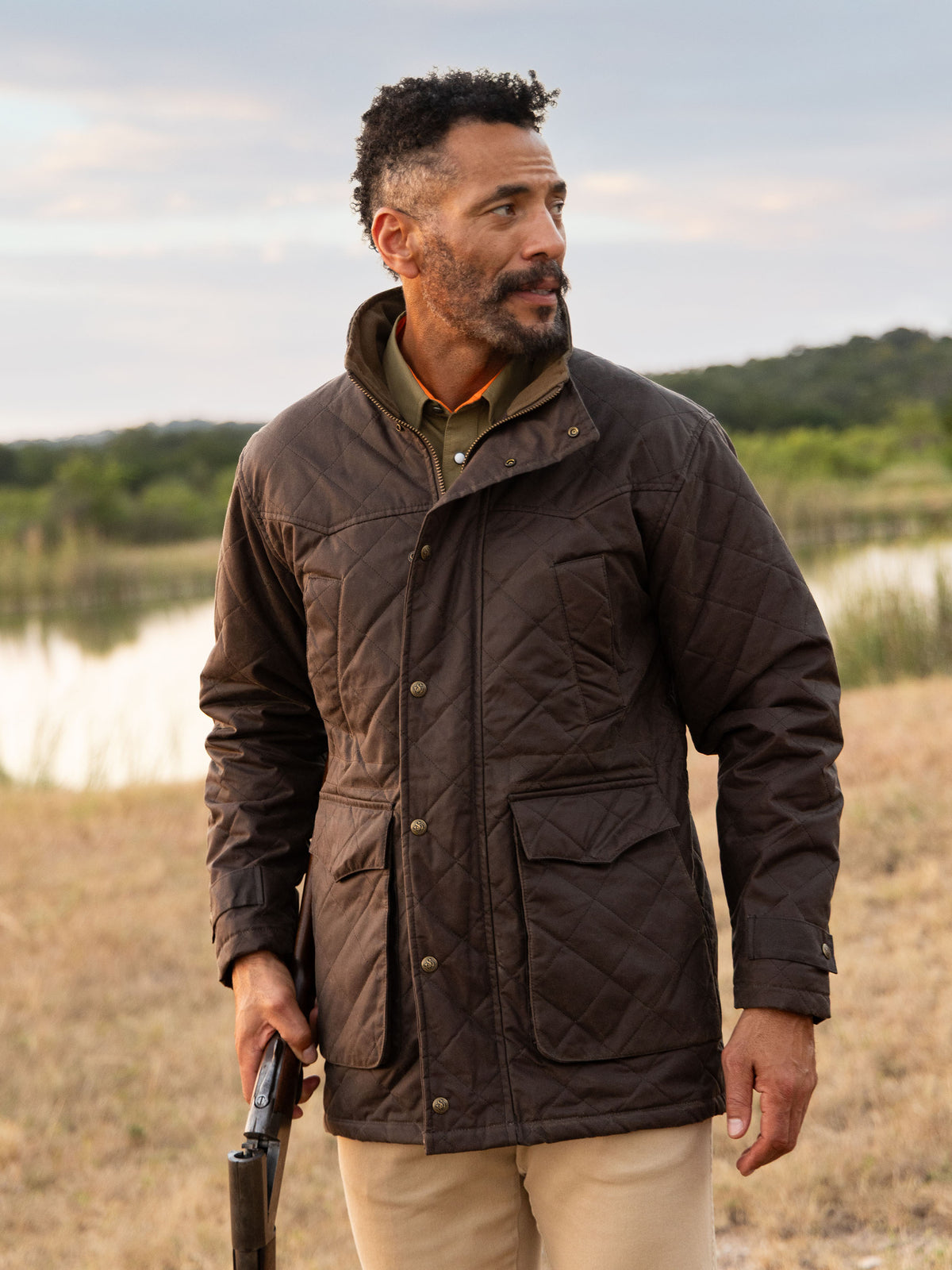Brown quilted jacket with stand collar and button-front, worn by model