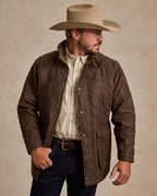 Oak-brown quilted jacket with zip front and stand collar, chest pockets visible.