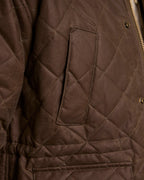 Brown quilted jacket front with diamond stitching and chest flap pocket