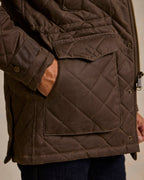 Brown quilted jacket with zip front, chest flap pocket, and snap button cuffs