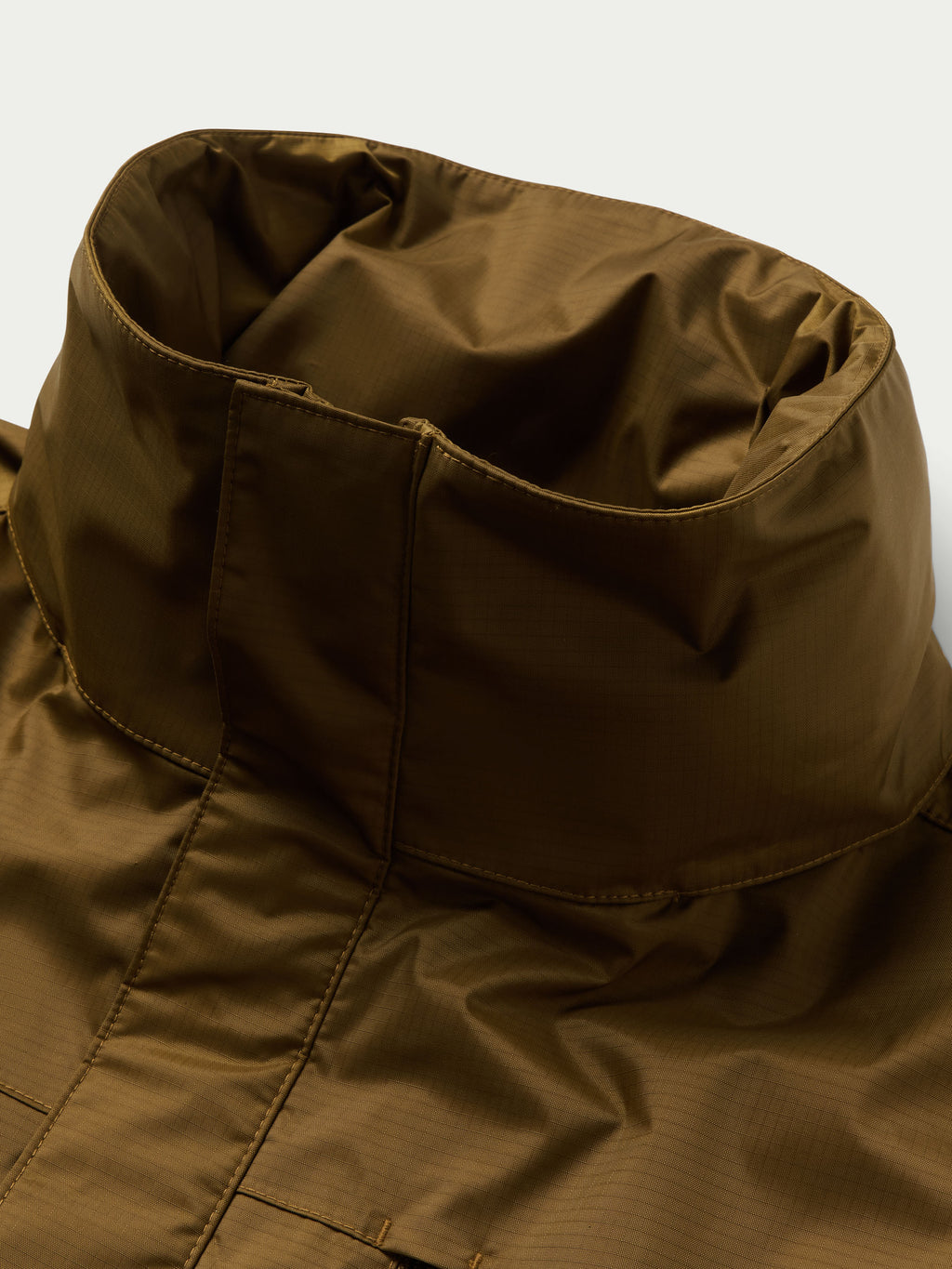 Brown rain jacket collar and front seam details with inner lining