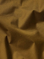 Brown rain jacket fabric texture with subtle water-resistant pattern