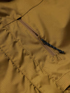 Brown rain jacket close-up of front zipper and stitched seams